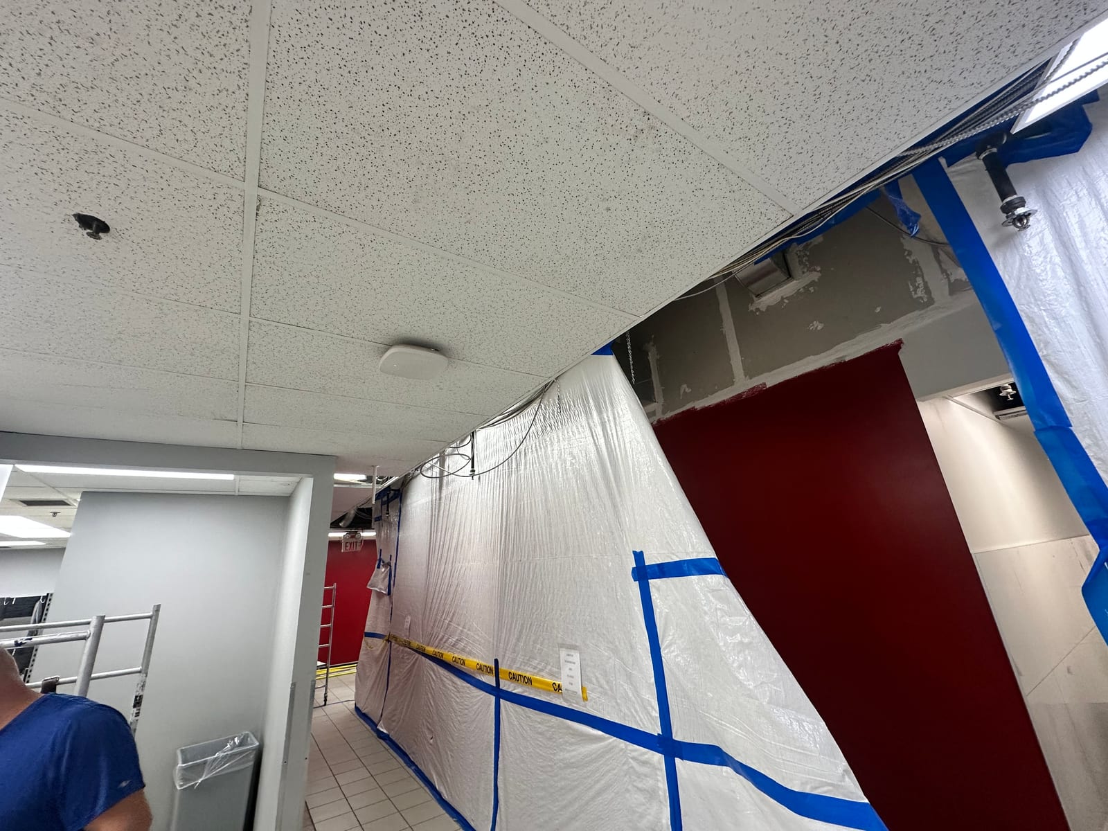 Commercial corridor with T-bar ceiling and renovation containment